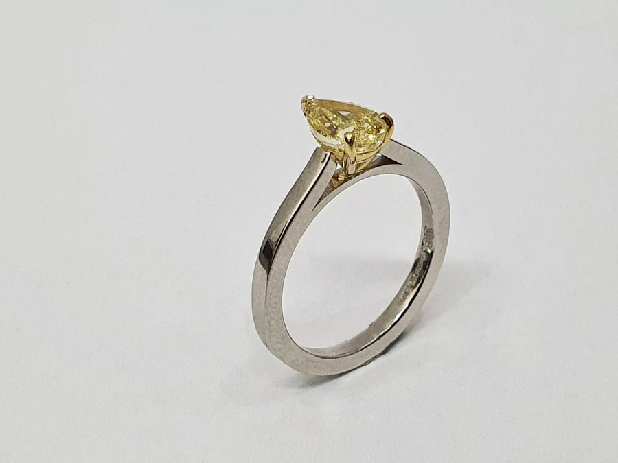 A stunning Natural Fancy Yellow Pear Shaped Diamond set in an 18 Carat Yellow Gold setting and a Platinum Band