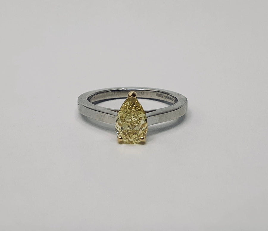 A stunning Natural Fancy Yellow Pear Shaped Diamond set in an 18 Carat Yellow Gold setting and a Platinum Band