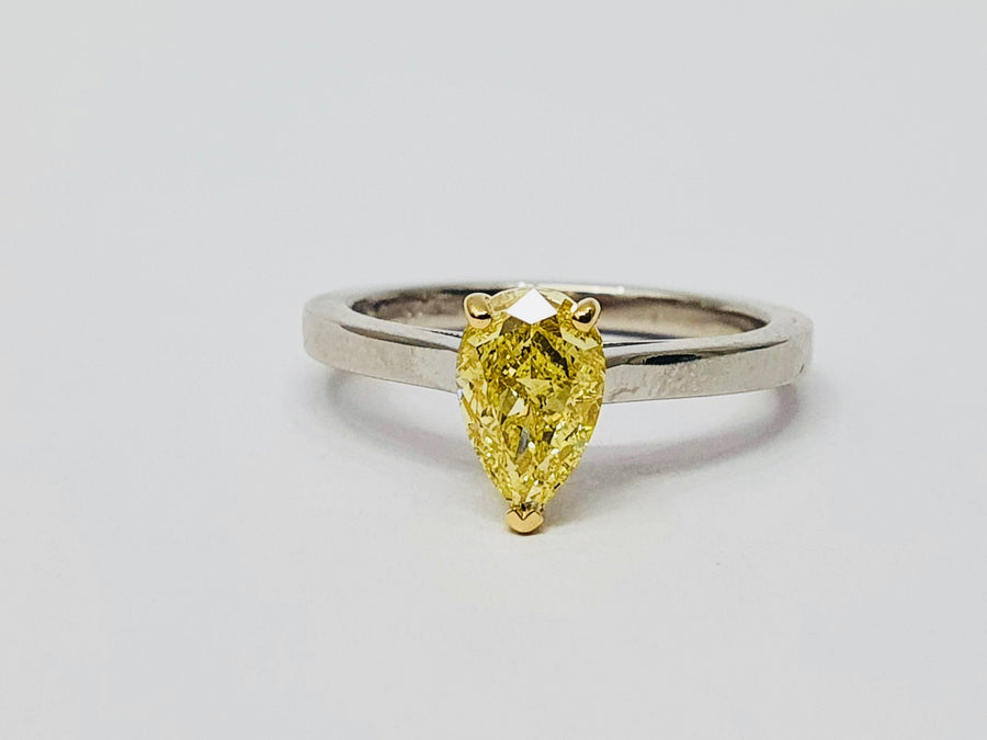 A stunning Natural Fancy Yellow Pear Shaped Diamond set in an 18 Carat Yellow Gold setting and a Platinum Band