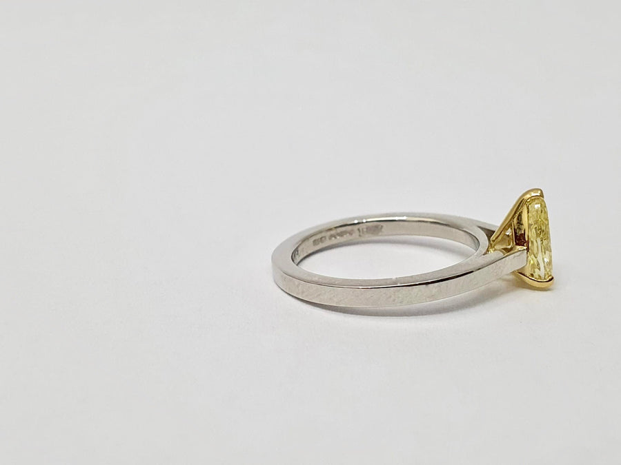 A stunning Natural Fancy Yellow Pear Shaped Diamond set in an 18 Carat Yellow Gold setting and a Platinum Band