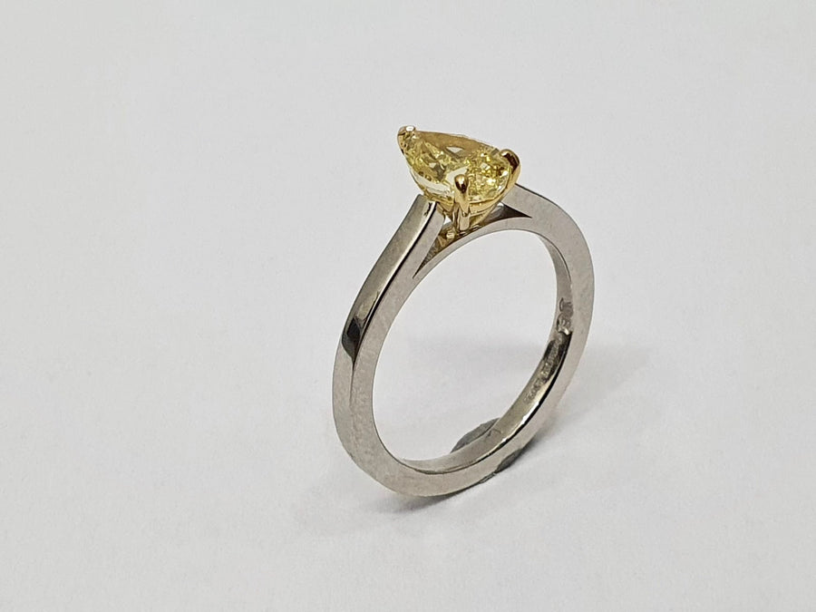 A stunning Natural Fancy Yellow Pear Shaped Diamond set in an 18 Carat Yellow Gold setting and a Platinum Band